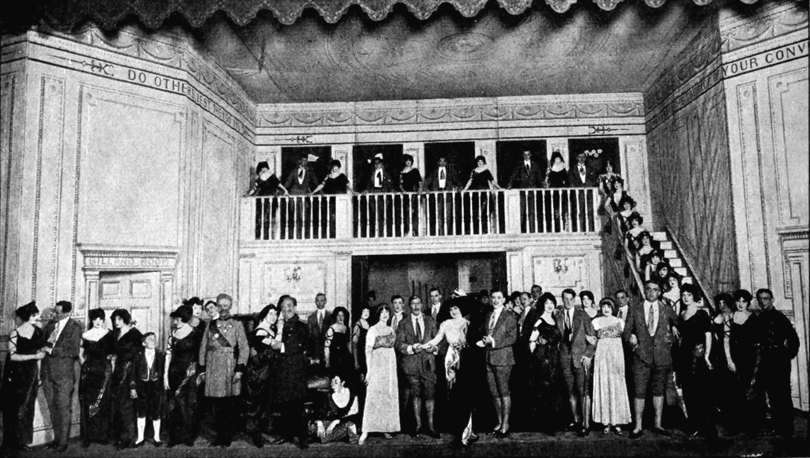 Group stage scene from a 1917 American production of Die Fledermaus, with chorus and principals in a multi-level set